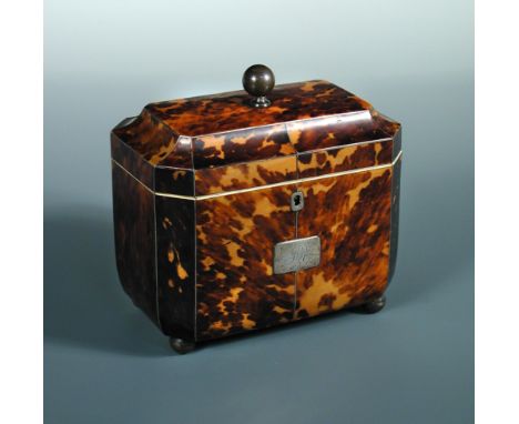A George III tortoiseshell tea caddy, the canted rectangular lid with ball finial and closing on bone fillets surrounding the