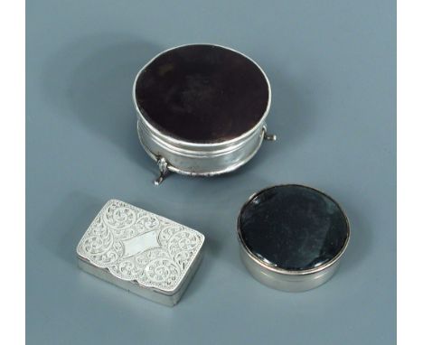 Three George V silver boxes, the first, a snuff box by Adie and Lovekin, Chester 1912, of plain rectangular form, the hinged 