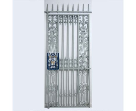 A George II wrought iron garden gate, with a later spiked overthrow, flanked by elegant scrollwork panels 249 x 102cm (97 x 4