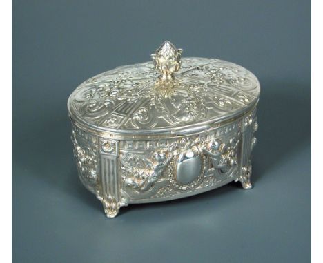 A silver oval dressing table box, sponsor's mark Samuel Boaz Landeck, Sheffield import hallmarks for 1900, embossed and chase