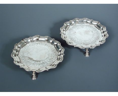 A pair of George II circular silver waiters by Samuel Courtauld, London 1751, 'Chippendale' style, with applied reeded border