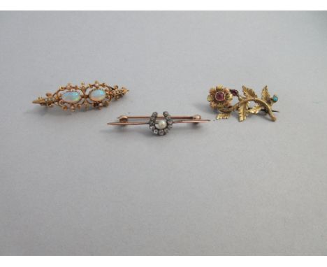 A diamond and pearl horseshoe brooch together with two other gem set antique brooches, the first with a rose metal knife-edge