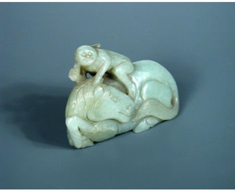 A carved grey green nephrite jade reclining horse with head looking back, a monkey on his back holding a flagstaff, Qing Dyna