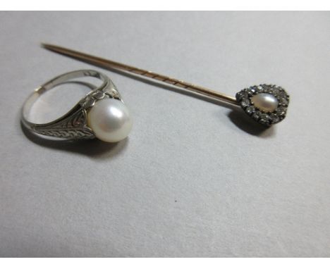 A half pearl and diamond stick pin together with a ring set with a single cultured pearl,  the pin with an oval shaped half p
