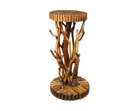 A rustic branch pedestal, with circular top applied with split round stick sections and on a column of entwined sticks, the c