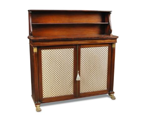 A Regency mahogany chiffonier, with raised shelf back and scrolling outline sides, above a base enclosed by satin and brass g