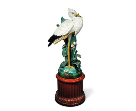 A 19th century majolica pottery heron stick stand, possibly Sarreguemines, the heron standing amongst lillies and bulrushes w