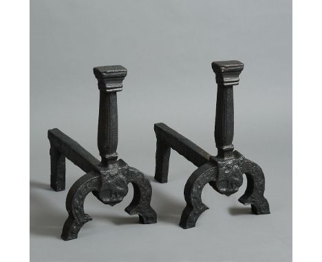 A pair of 17th century Wealden cast iron Andirons, Mayfield, Sussex, bearing the Phoenix shield below the capped and fluted c