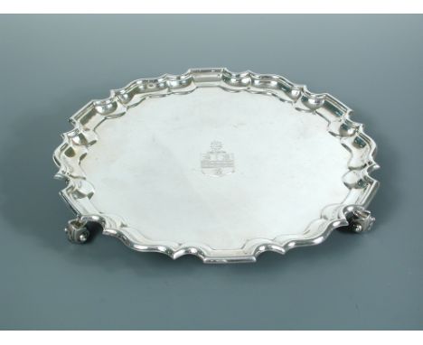 A George V circular silver salver, by Theodore Rossi, London 1927, 'Chippendale' style, the field engraved with a crest, rais