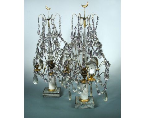 A pair of three light lustre candelabra, the glass beads hung from gilt wires about the central obelisks topped by crescents,