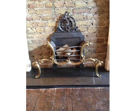 A 19th century cast iron fire grate by Thomas Elsley, in the rococo manner with brass c scroll mounts after a design by Thoma