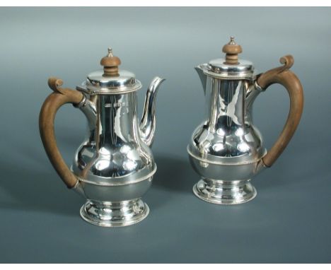 An Edward VII silver bachelor café-au-lait set, by Henry Clifford Davis, Birmingham 1924, comprising a baluster shaped coffee