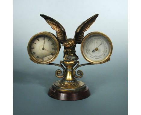 A gilt spelter mounted desk timepiece and aneroid barometer, the balance wheel movement with silvered dial with central eagle