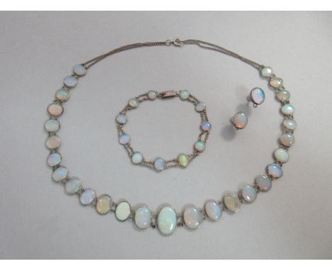 An Arts and Crafts opal set necklace and bracelet suite with matched pair of earrings, the necklace with graduated oval thin 