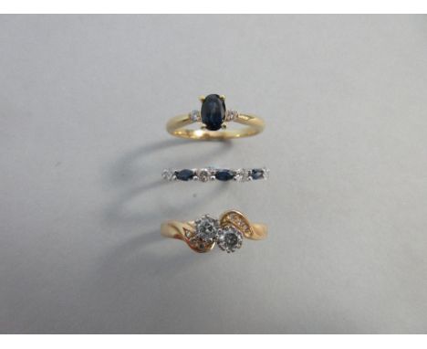 A sapphire and diamond half hoop ring, a diamond crossover ring and a sapphire and diamond three stone ring, the first set wi