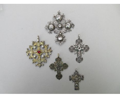 An 18th century Iberian pendant cross set with rock crystals together with four later Russian pendant crosses, the first of p