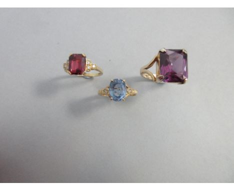 An 18ct gold, pink tourmaline and diamond ring together with a similar lilac blue sapphire ring and a purple synthetic sapphi