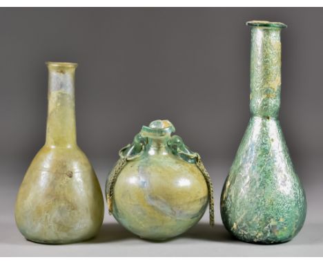 Three Roman Glass Vessels, Circa 1st/4th Century AD - Unguentarium of light green tint, 6.25ins high, another 7.75ins high, a