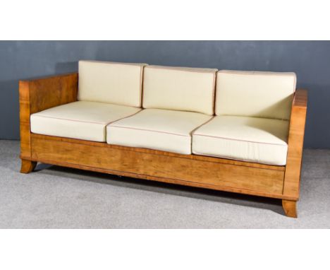 A 1930s Continental Walnut Day Bed, of Art Deco design, on splayed feet with cream upholstered loose cushions for same, 82ins