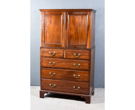 A 19th Century Mahogany Millinery Cabinet, the upper part with moulded cornice fitted one shelf enclosed by a pair of panelle