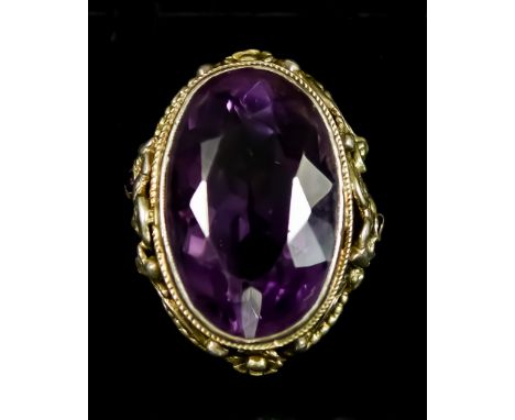 An Amethyst Dress Ring, in silvery metal mount, set with a faceted oval amethyst, 18mm x 28mm, the mount pierced and cast wit