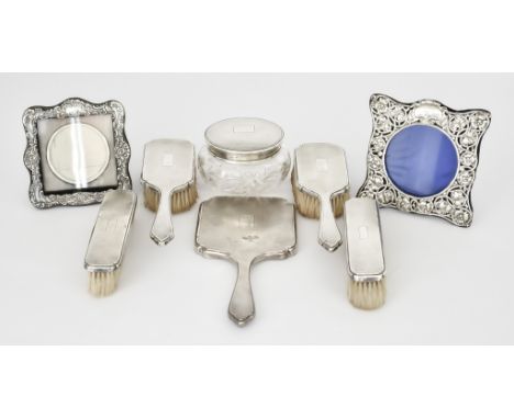 A Victorian Silver Backed Seven-Piece Dressing Table Set and Two Edward VII Silver Photograph Frames, the dressing table set 