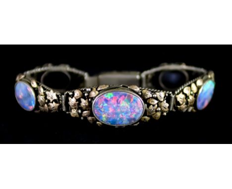 A Five Stone Fire Opal Bracelet, 20th Century, silver base with 9ct gold leaves to the front set with five fire opals, 13mm x