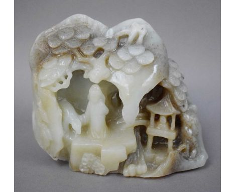 A Chinese Carved Celadon Jade Boulder, two figures in a mountainous landscape with pine trees, 14cm wideSmall amount of loss 