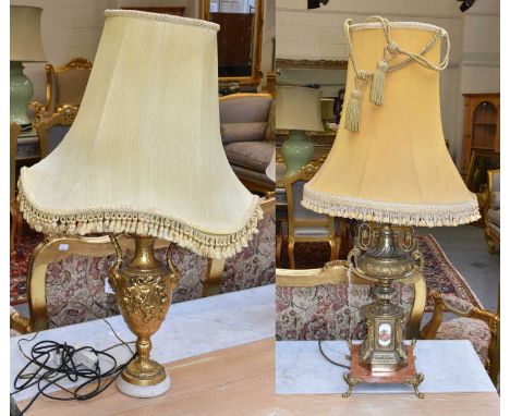 A Gilt Metal Table Lamp with Porcelain Plaque, together with a similar example (2)