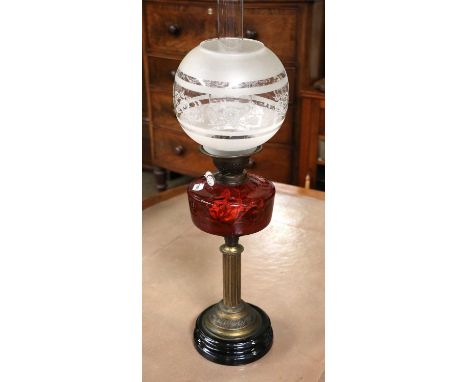 A Victorian Oil Lamp, with a ruby glass reservoir, 46cm to the burner 