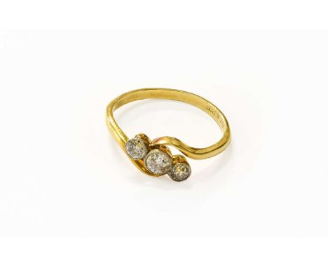 A Diamond Three Stone Twist Ring, stamped ‘18CT&amp;PT’, finger size OThe ring is in good condition. The approximate qualitie