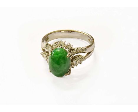 A Chinese Green Hardstone and Diamond Cluster Ring, indistinctly marked, finger size R1/2The ring is in good condition howeve
