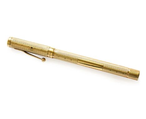A Gold Waterman's Ideal Fountain Pen, London, 1929, 9 Carat with screw cap and overall engine-turned finish, 13.3cm longFully