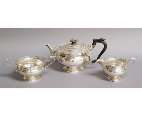 A Three-Piece George V Silver Tea-Service, by Walker and Hall, Sheffield, 1928, each with piece with shaped shell and reeded 
