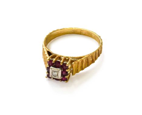 An 18 Carat Gold Ruby and Diamond Cluster Ring, finger size TThe ring is in good condition. It is hallmarked with sponsor's m