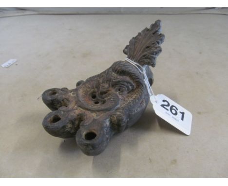A Peruvian pottery oil lamp