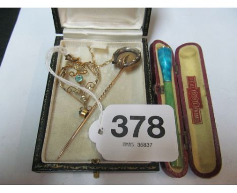 An Edwardian pendant and chain, gold horseshoe tiepin and enamel cigarette holder in case jade style holder