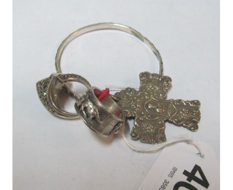 Two silver rings, a white metal cross and bangle