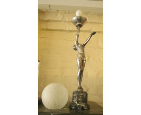 An Art Deco style silver coloured lamp lady balancing a spherical shade