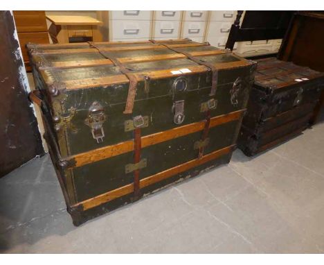 A large wooden bound/canvas Travel Trunk with metal mounts and corners  
