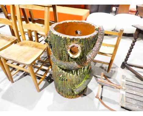 An early 20th century glazed earthenware plant holder as a tree trunk