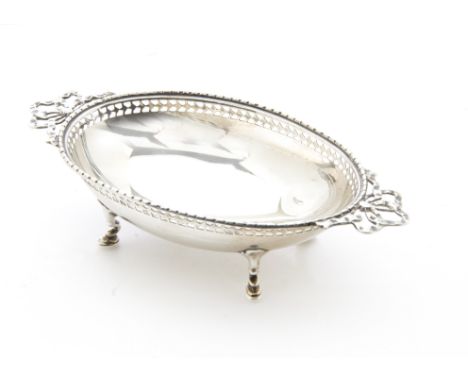 An early George silver bon bon dish from Mappin &amp; Webb, oval with ribbon twin handles on four supports, Sheffield 1914, 2