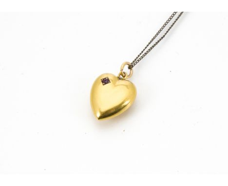 A late Victorian 15ct gold and ruby heart shaped pendant, 1.7g, on a gold plated chaint is 15ct