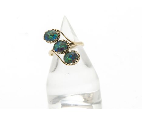 A modern three stone opal dress ring, the three doublets in crossover style mount, hallmarked, 4.1g and size O 