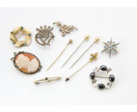 A small collection of vintage brooches and stick pins, including a 1977 silver double heart brooch and an Iona silver Celtic 