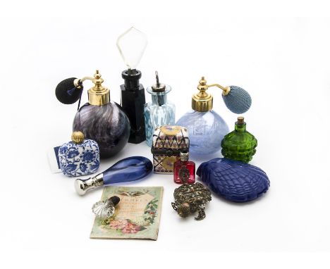 A collection of vintage and modern scent and perfume bottles, including an Art Deco cut black glass example with clear stoppe