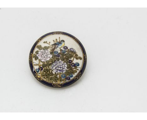 A vintage Satsuma style pottery brooch, circular with scene of bird amongst flowers, white metal backing, 5cm 
