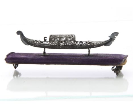 A vintage silver filigree miniature model of a gondola, on purple velvet plinth, lacks a support 