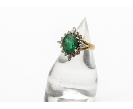 A 1960s 18ct gold emerald and diamond dress ring, the large oval green stone within brilliant and marquise cut diamonds, 7.3g