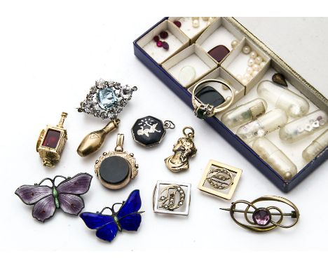 A small group of gold and other jewellery items, including a spinning fob seal, two enamel butterfly brooches, a ring, two in